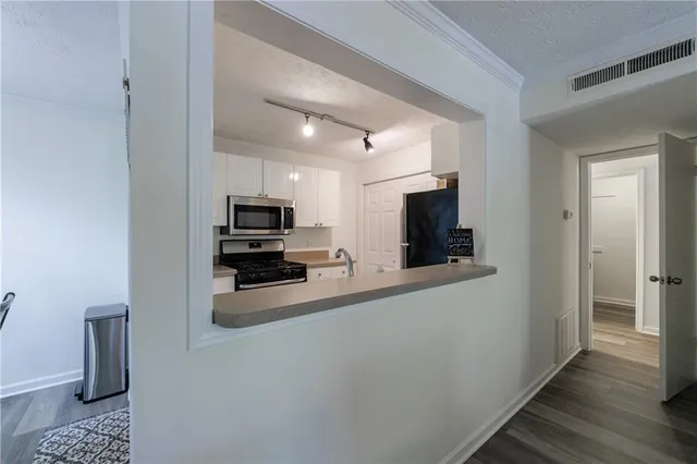 a view of a kitchen from the hallway