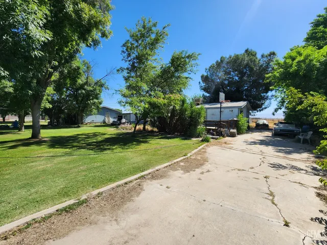 a view of a house with garden and a trees