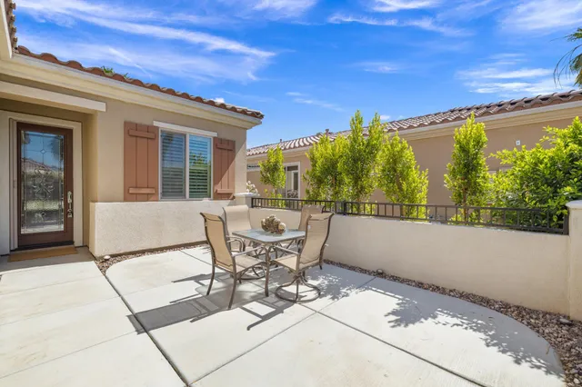 a view of a patio with table and chairs and potted plants