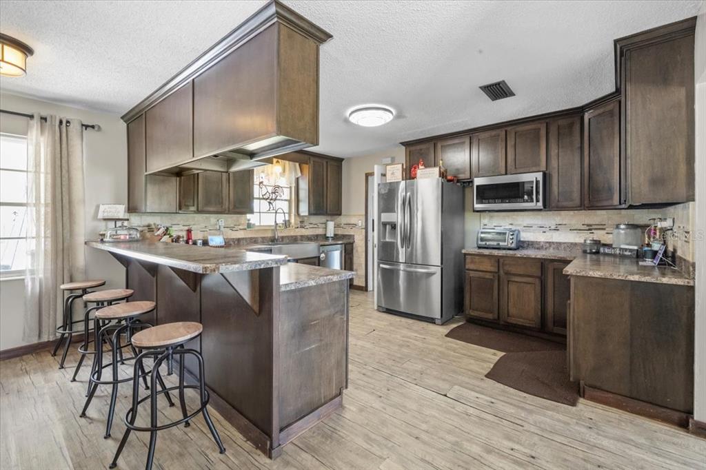 7422 County Road 231 Lake Butler, FL 32054 - Photo 13 of 57 a kitchen with stainless steel appliances a stove a sink dishwasher a refrigerator and a oven
