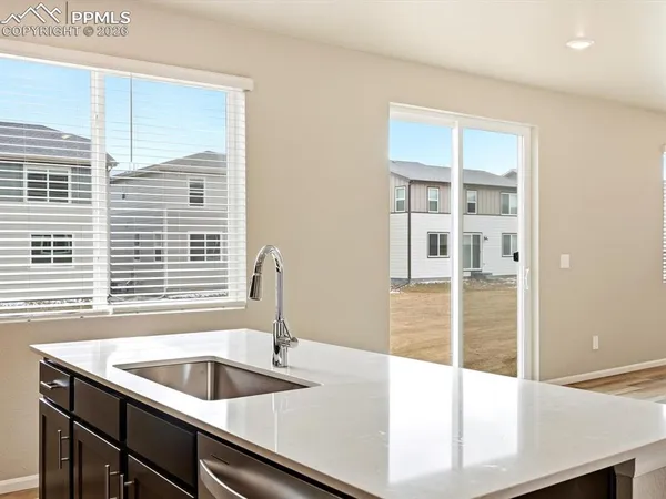 a kitchen with a sink and large window