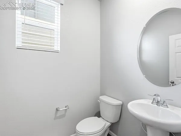 a white toilet sitting next to a bathroom sink