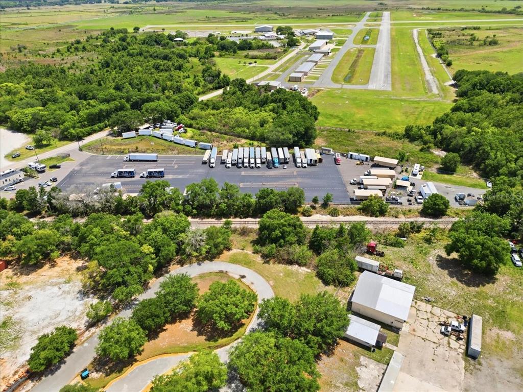100 South Airport Road Lake Wales, FL 33859 - Photo 8 of 28 an aerial view of a house with a garden and swimming pool