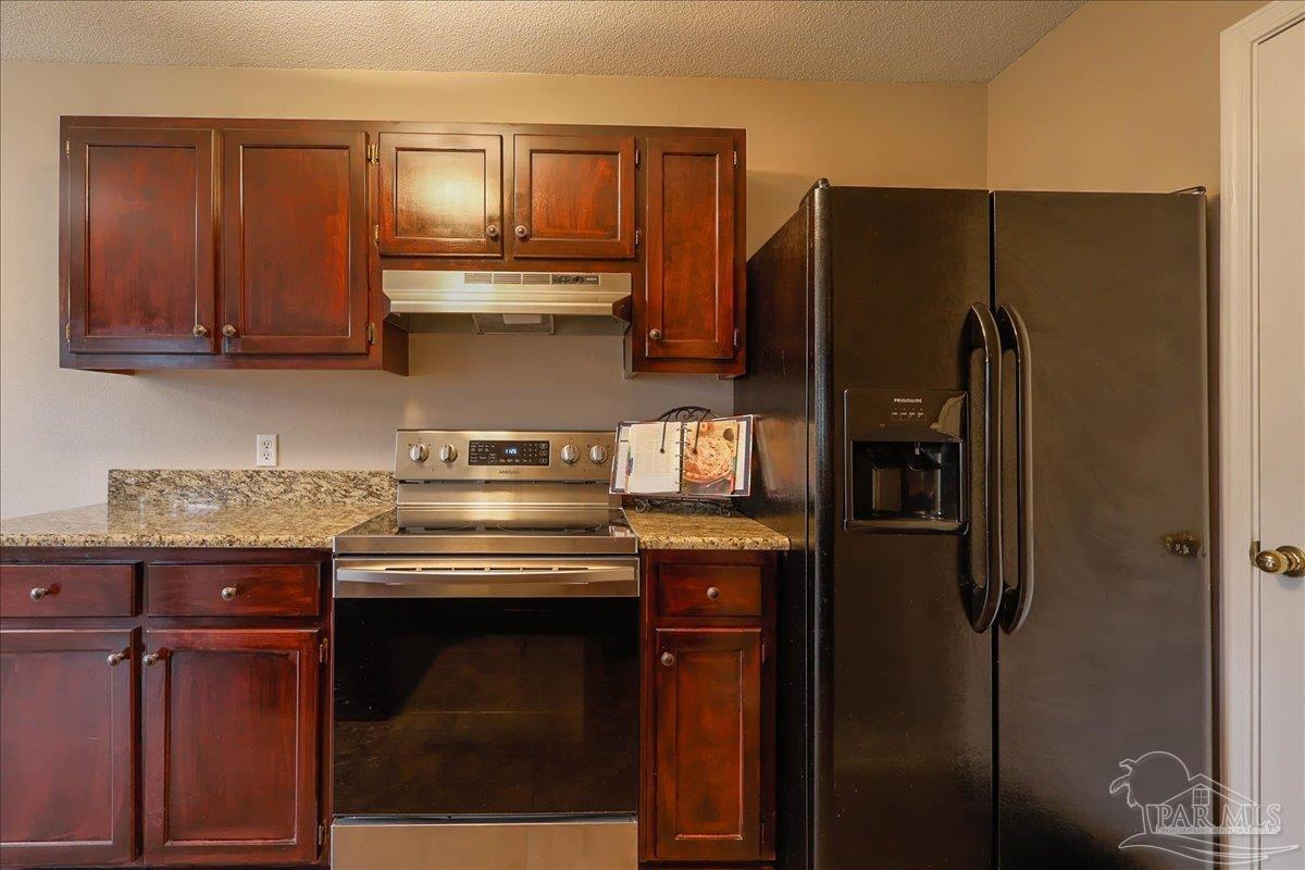 3256 Two Sisters Way Pensacola, FL 32505 - Photo 15 of 40 a kitchen with stainless steel appliances granite countertop a stove and a refrigerator