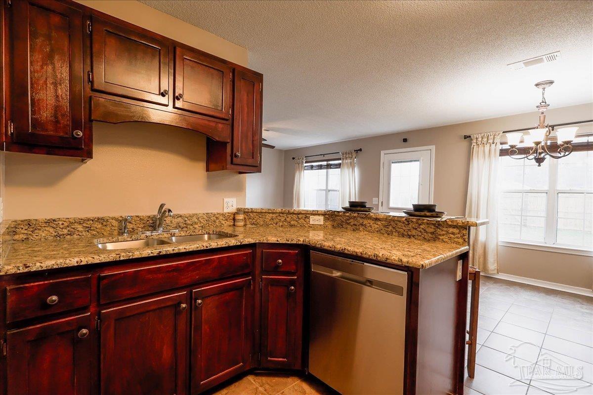 3256 Two Sisters Way Pensacola, FL 32505 - Photo 17 of 40 a kitchen with granite countertop stainless steel appliances and wooden cabinets