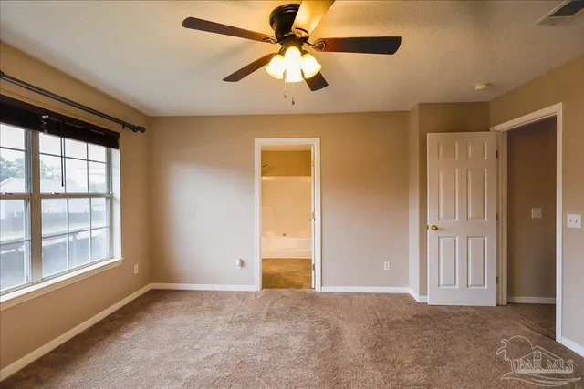 a white toilet sitting next to a shower curtain