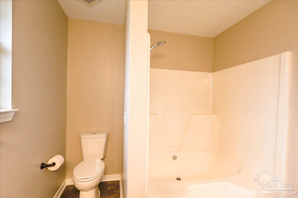 3256 Two Sisters Way Pensacola, FL 32505 - Photo 25 of 40 a white toilet sitting next to a shower curtain