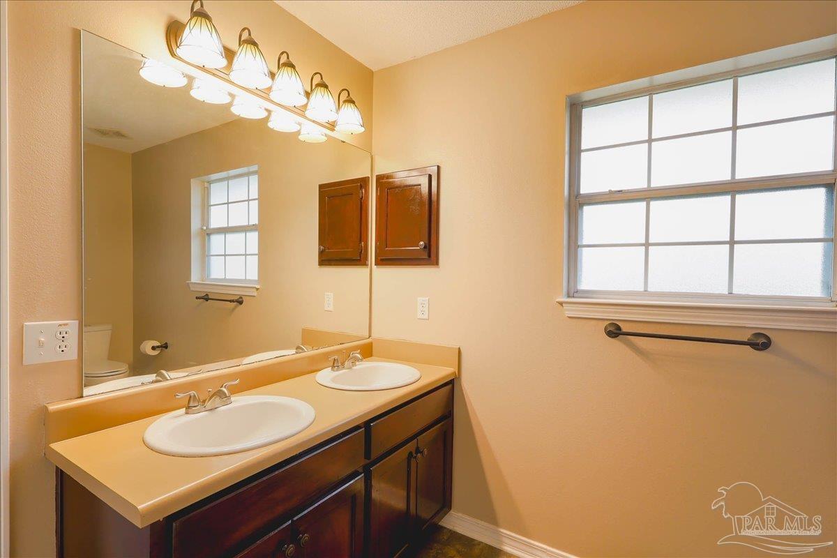 3256 Two Sisters Way Pensacola, FL 32505 - Photo 26 of 40 a bathroom with a sink and a mirror
