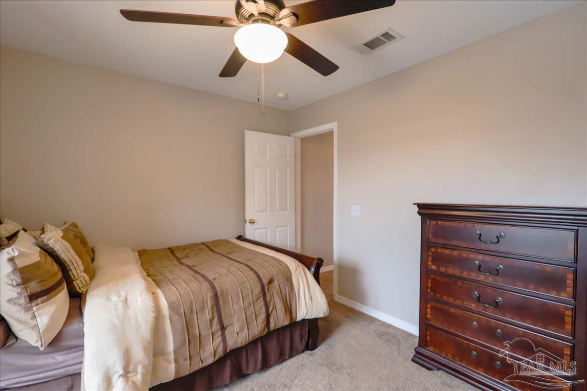3256 Two Sisters Way Pensacola, FL 32505 - Photo 34 of 40 a bedroom with a bed and a chandelier