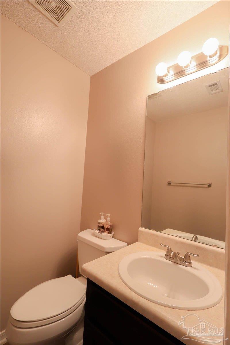 3256 Two Sisters Way Pensacola, FL 32505 - Photo 35 of 40 a bathroom with a sink a toilet and mirror