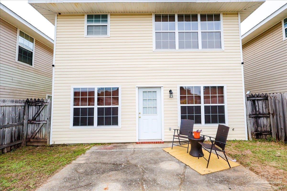3256 Two Sisters Way Pensacola, FL 32505 - Photo 38 of 40 a view of a house with a patio and a yard