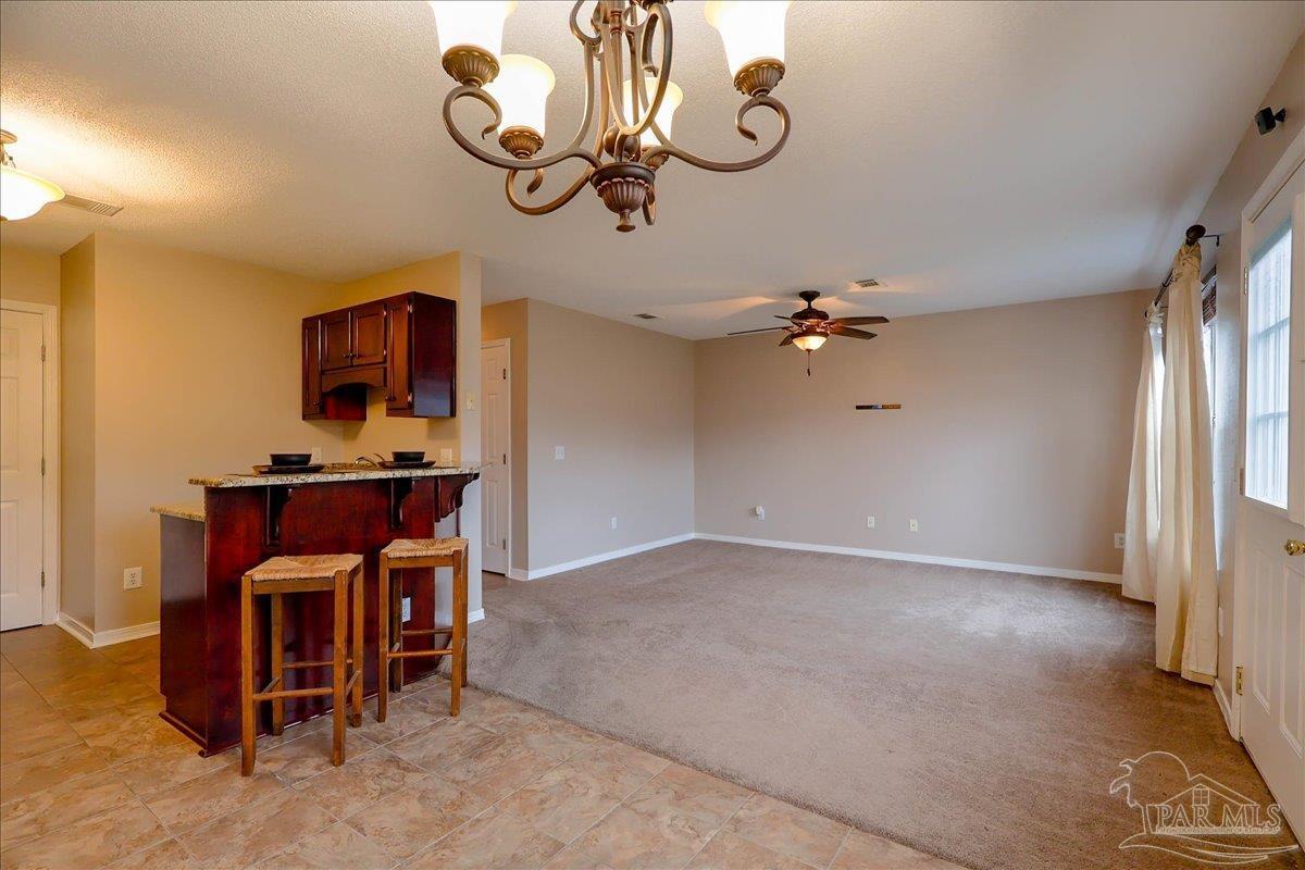 3256 Two Sisters Way Pensacola, FL 32505 - Photo 9 of 40 a view of a room with a chandelier fan and windows