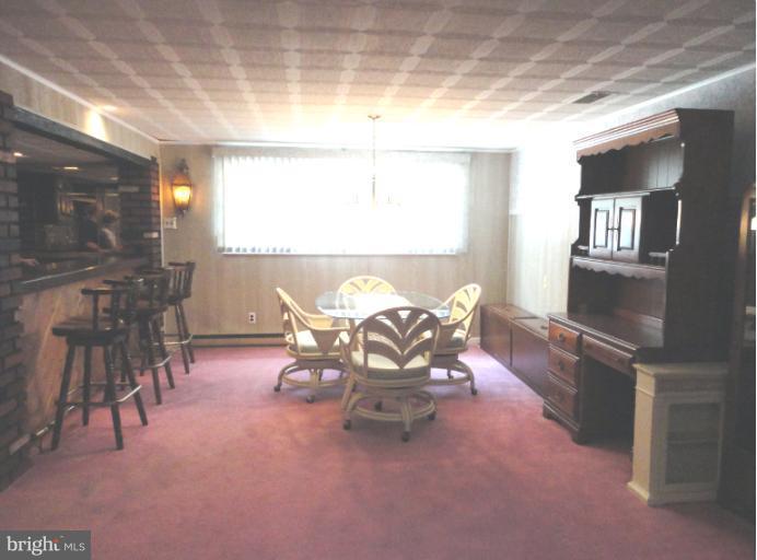4807 Torpoint Road Nottingham, MD 21236 - Photo 22 of 26 a dining room with furniture and a large window