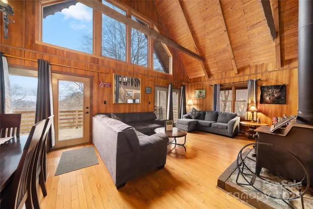 a living room with furniture fireplace and a large window