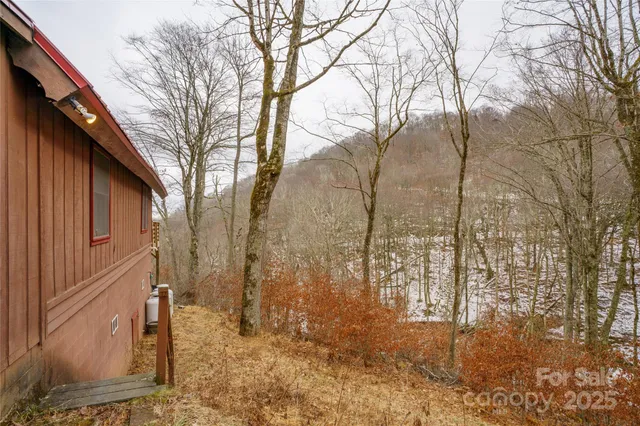 a roof deck with table and chairs under an umbrella