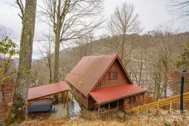 a front view of a house with yard and sitting area