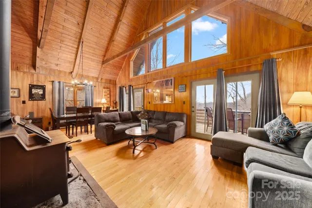 a living room with furniture a couch and large windows