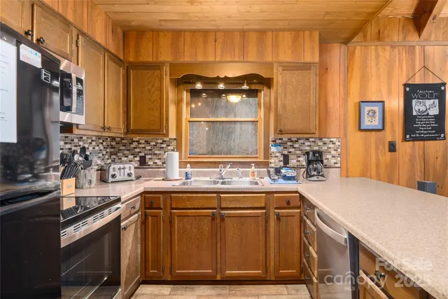 a kitchen with a sink and a stove top oven