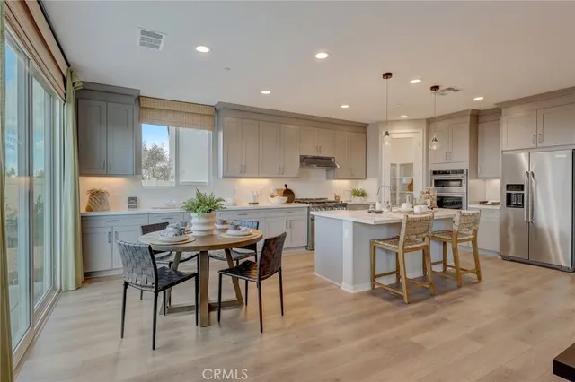 a kitchen with a white center island and cabinets