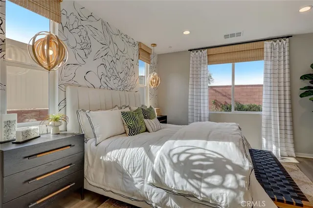 a bedroom with a bed and a wall painting