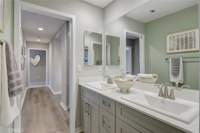 a bedroom with a bed and painting on the wall