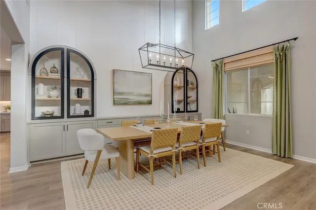 a view of a dining room with furniture and chandelier