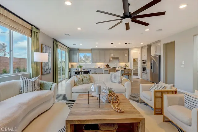 a living room with furniture and a view of kitchen