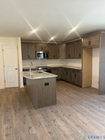 a view of kitchen with sink and window