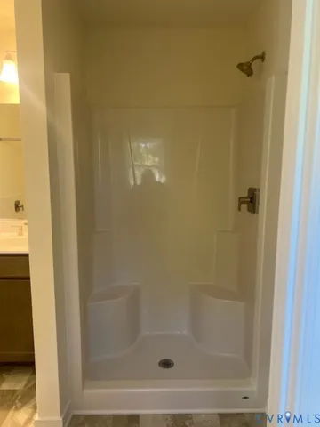 a bathroom with a shower and a bath tub