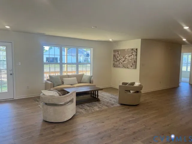 a living room with fireplace furniture and wooden floor