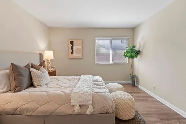 a bedroom with a bed and a window