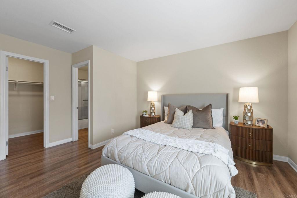 101 South Spruce Street, Unit 232 Escondido, CA 92025 - Photo 17 of 33 a bedroom with a bed and wooden floor