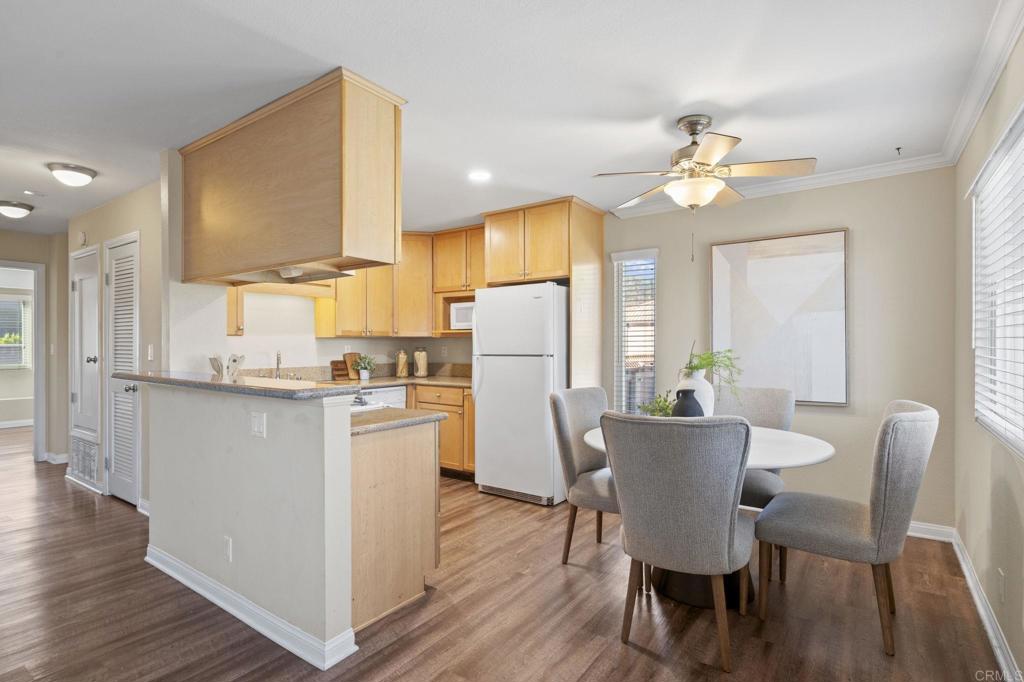101 South Spruce Street, Unit 232 Escondido, CA 92025 - Photo 8 of 33 a view of a dining room with furniture a chandelier and wooden floor