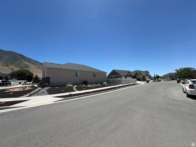 118 Tram Rock Rd. Lake Point, UT 84074 - Photo 3 of 34 Single-story residence featuring a neutral stucco exterior, a dark shingle roof, and a stone facade accent