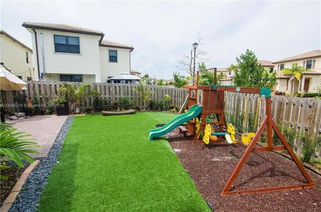 a view of a house with backyard and a slide