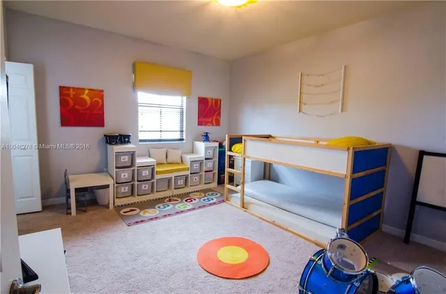a bedroom with bunk bed and a dresser