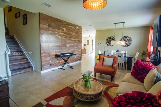 a living room with furniture chess board and a chandelier