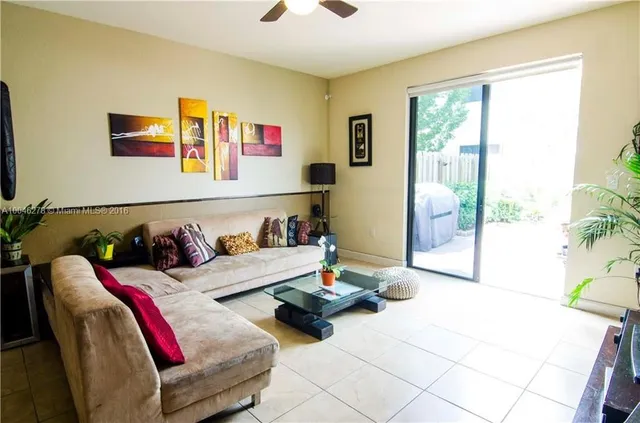 a living room with a couch and a floor to ceiling window