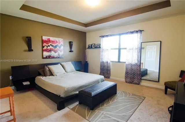 a bedroom with a bed and a couch