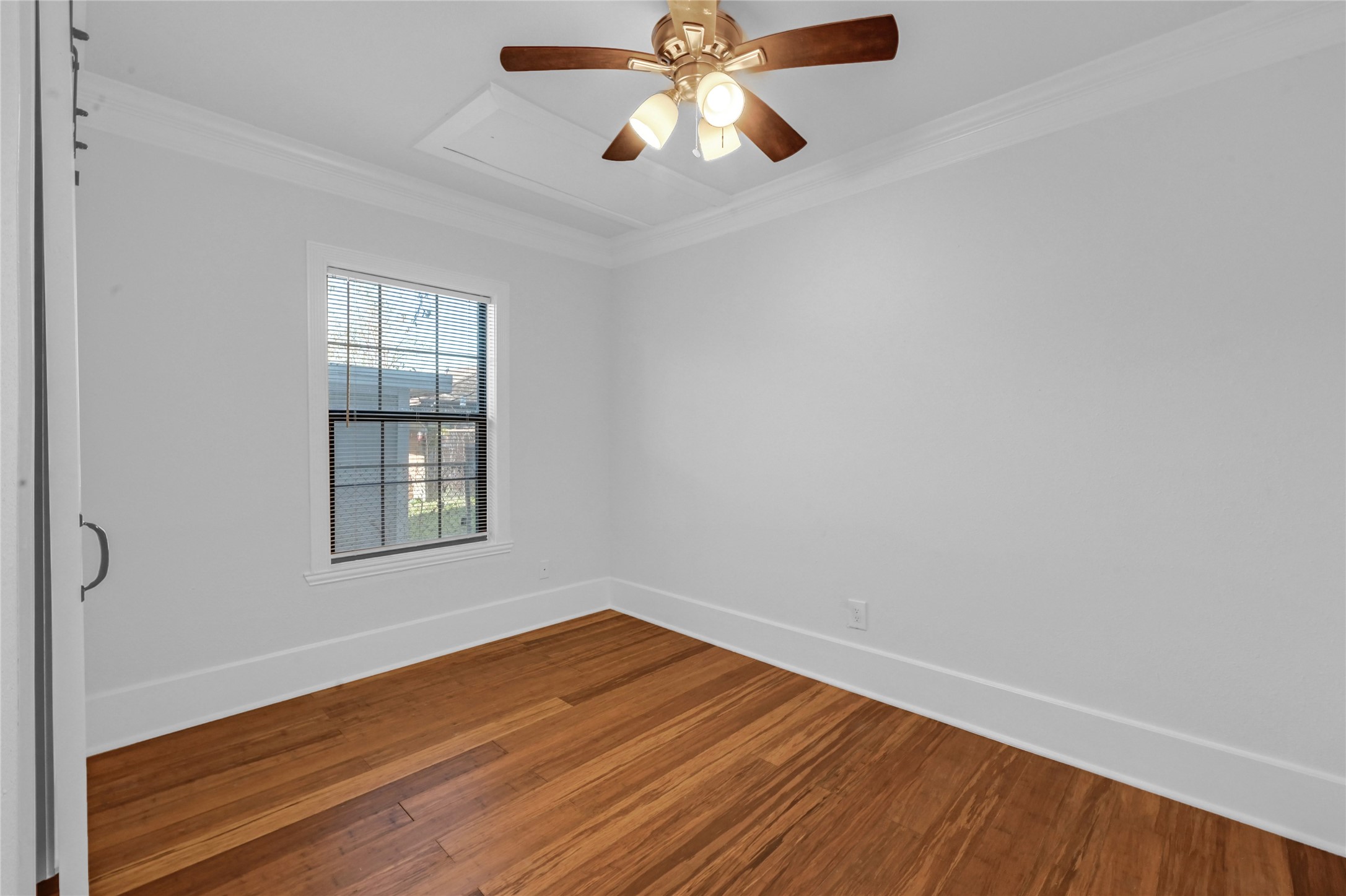 1633 Fourcade Street, Unit A Houston, TX 77023 - Photo 5 of 7 wooden floor in an empty room with a window