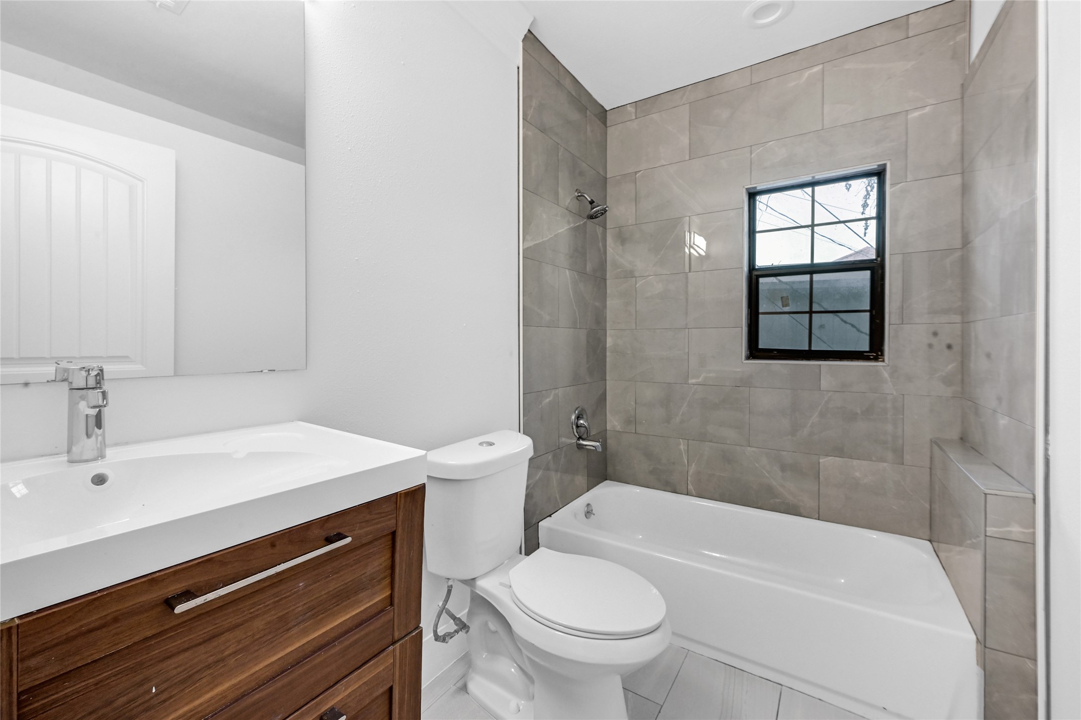 1633 Fourcade Street, Unit A Houston, TX 77023 - Photo 6 of 7 a bathroom with a sink a toilet and shower