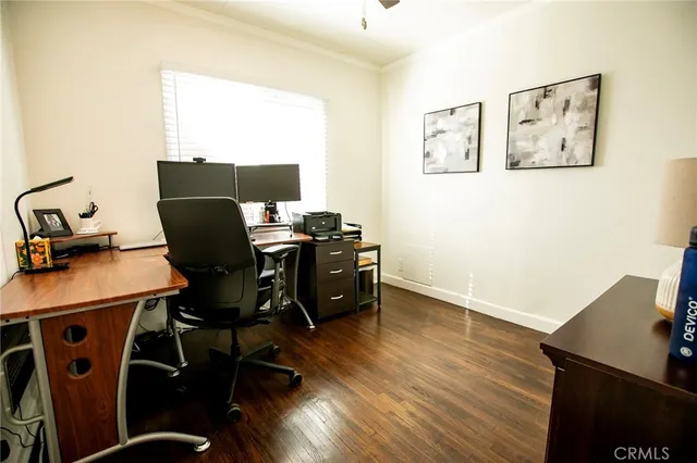 a view of a workspace with furniture and wooden floor