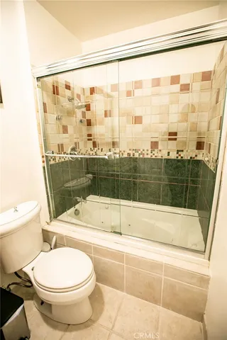 a bathroom with a toilet and a shower