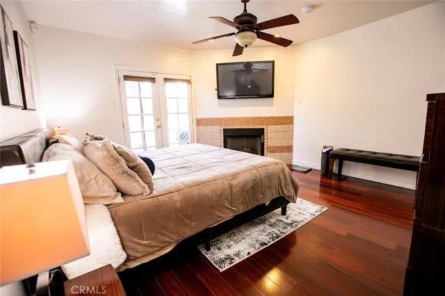 a spacious bedroom with a bed and wooden floor