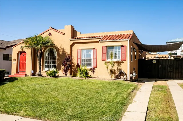 a front view of a house with a big yard