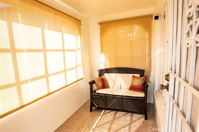 a bed sitting in a bedroom next to a window