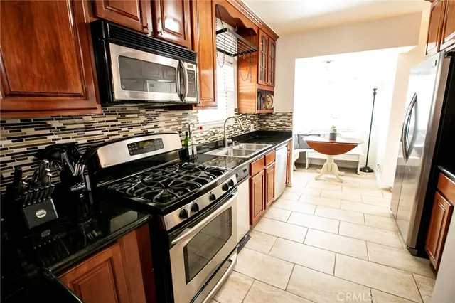 a kitchen with a stove a sink and a microwave