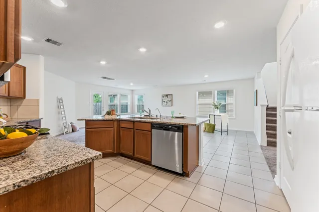 a kitchen with stainless steel appliances granite countertop a sink and cabinets