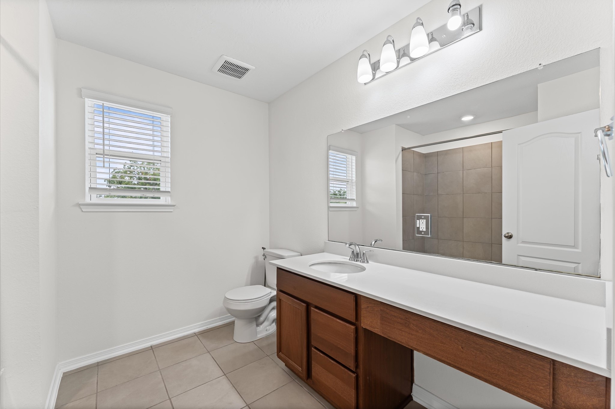 5031 Gazelle Leap Lane Richmond, TX 77406 - Photo 22 of 30 a bathroom with a double vanity sink a toilet and a mirror
