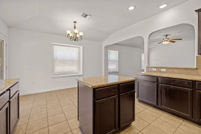 a kitchen with granite countertop a sink and a stove